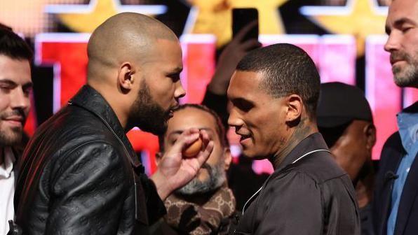 Chris Eubank Jr holds an egg up to Conor Benn's face