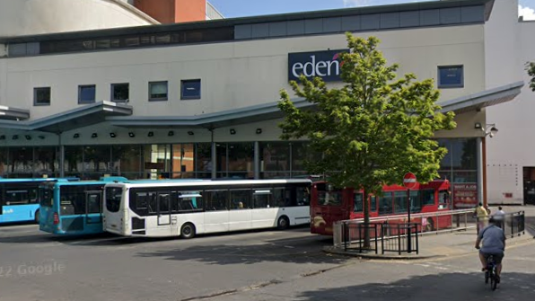 Google Maps view of blue, white and red single-decker buses parked outside Eden Shopping Centre