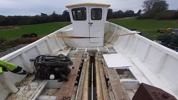 A boat being fitted with an electric motor