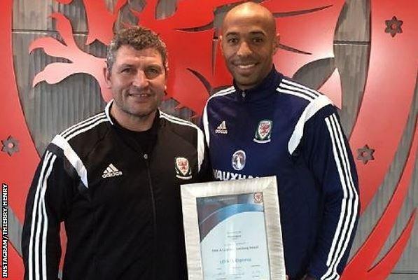 Thierry Henry poses with Wales assistant manager Osian Roberts after completing his coaching badges