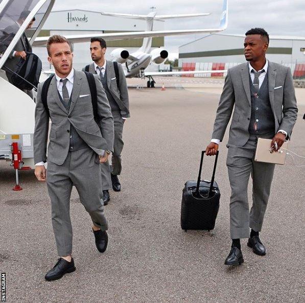 Barcelona players in expensive grey suits