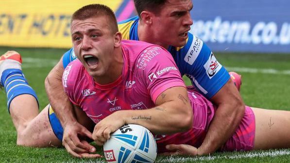 Hull Kingston Rovers' Mikey Lewis scores a try despite the attentions of Leeds Rhinos' Brodie Croft