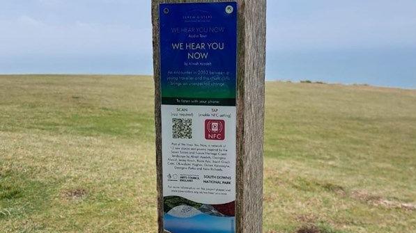 A plaque on a wooden post in the South Downs