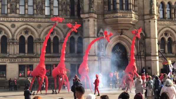 Crowds watch the performance which combined opera and circus acts with puppetry