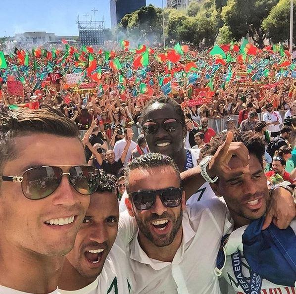 Cristiano Ronaldo (left) and team-mates pose for a photo in front of Portugal fans