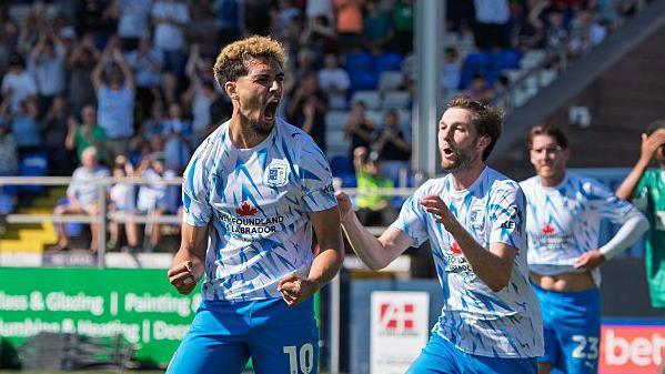 Tyler Walker (left) is congratulated by Tom Barkhuizen after scoring for Barrow at home to Notts County