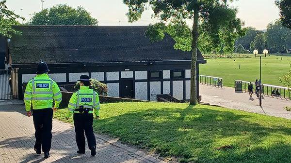 Two uniformed officers walking through Forest Rec