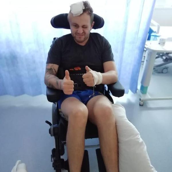 Adam Harcombe in a wheelchair in hospital