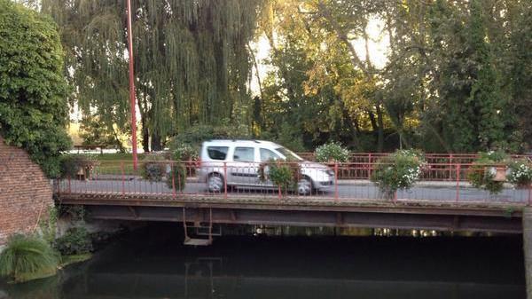 A silver car is seen crossing the Pont Blackburn bridge over the Somme river in Peronne, France.