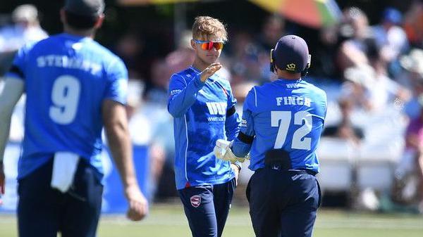 Jadyn Denly high-fives his Kent teammate, Harry Finch