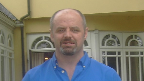 Paul Francis O'Boyle is wearing a blue shirt and has a goatee style beard.