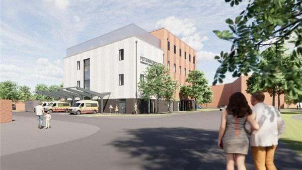 Artist impression of the new centre- a white building with ambulances parked in front under metal shelters and people walking towards it 