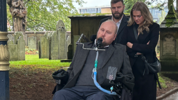 Matt Hampson, in a wheelchair, arrives at the church with two other people