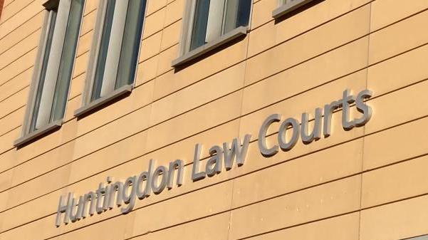 The words 'Huntingdon Law Courts' written on the side of a cream building.