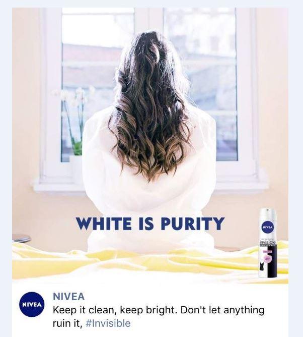 a screenshot of the advert: a woman is pictured back to camera in a white robe with the words 'white is purity' and an image of the can.