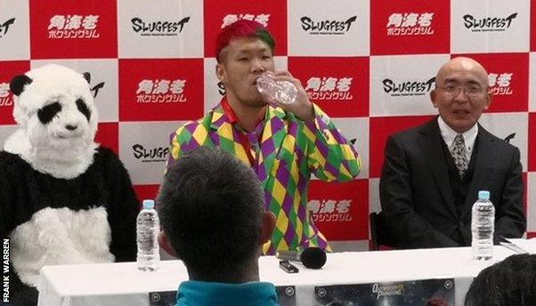 Japan's Fujimoto sat next to a panda at a news conference