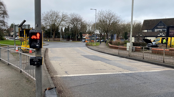 Priory Roundabout in Nottingham with a Miller and Carter restaurant to the right. At the front of the image there is a pedestrian crossing which is displaying a red light.