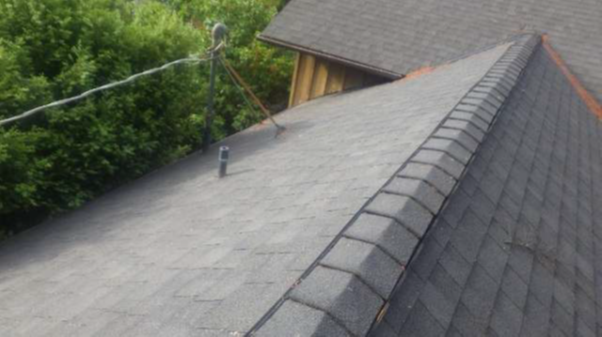 A close up of a sloping grey roof that appears to be intact, with no obvious defects