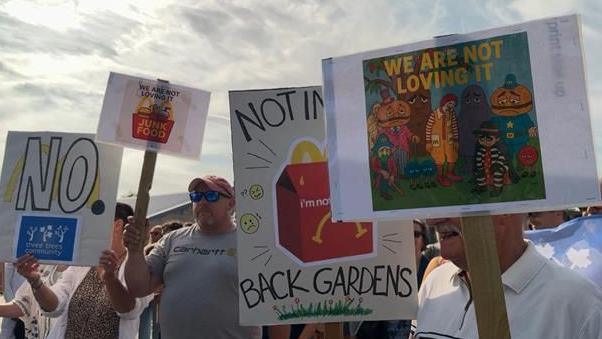 Residents holding placards against McDonald's