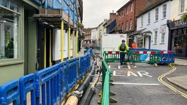 Barriers line a street which is closed to traffic