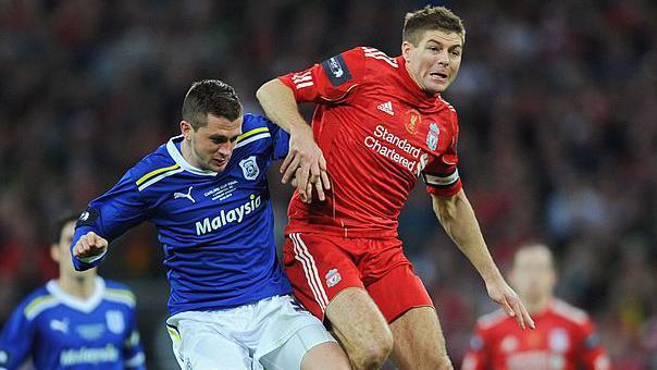 Liverpool's Steven Gerrard battles with Cardiff's Andrew Taylor during the 2012 League Cup final