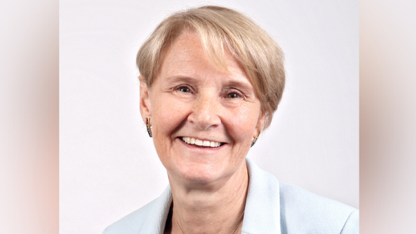 A portrait photo of Dr Cathy Jack. She is wearing a light blue blazer and a navy top. 