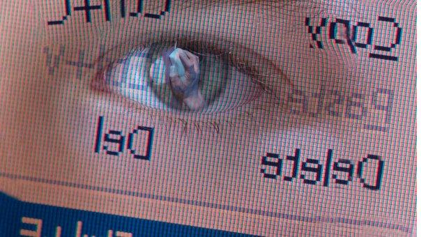 Child's eye reflected in computer screen