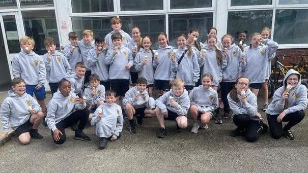 Group of children wearing grey hoodies at St Margaret Mary’s Catholic Junior School