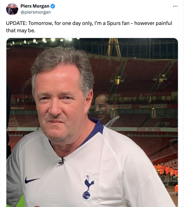 Piers Morgan wearing Spurs shirt and grimacing.