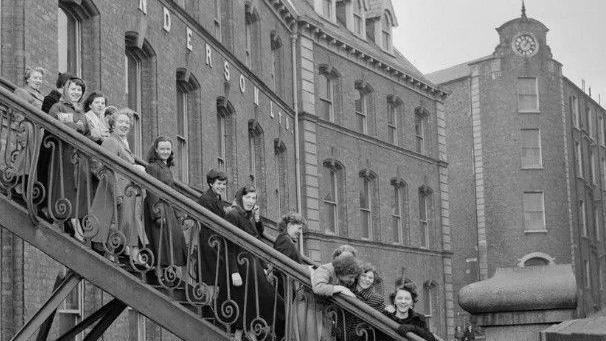 Workers seen leaving Tillie and Henderson's shirt factory in November 1955