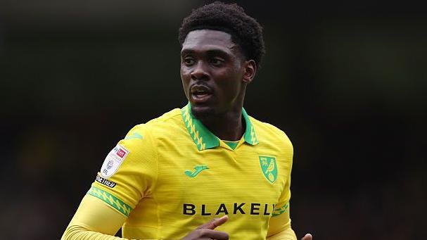 Mohamed Toure in his yellow Norwich City shirt.