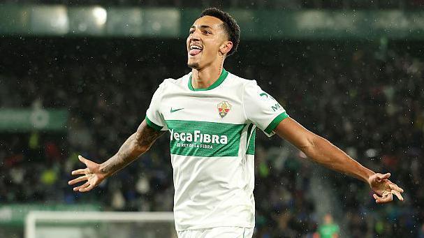Alvaro Rodriguez celebrates a goal for Elche with his arms out wide
