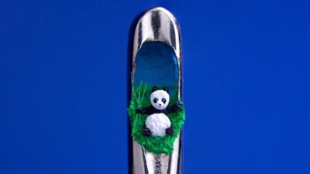 A panda sculpture in the eye of a needle