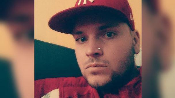 A selfie of Lewis Skelton wearing a red cap and jacket with a nose stud and short beard