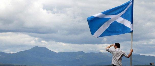 Man looking out over Scottish hills