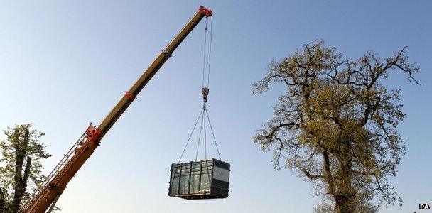 Crane lowering a rhino into her enclosure