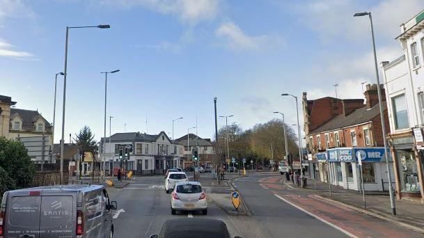 London Road heading into Reading, the road is flanked by shops and is two lanes on the left and one lane and a pre-existing bus lane on the far right lane.