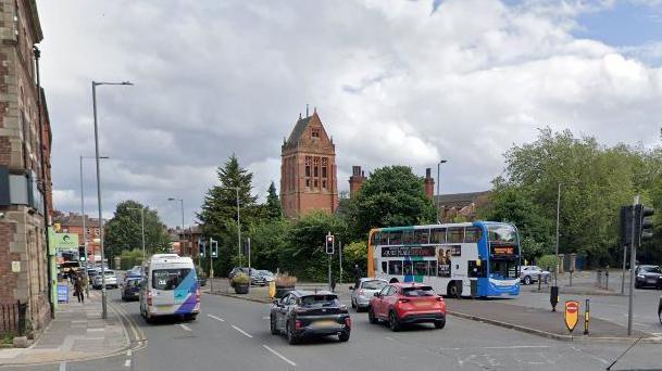 Google street view of Smithdown Road with cars and a bus driving through it