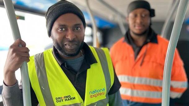 A National Express worker on a bus