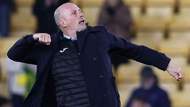 Norwich City manager Philippe Clement punches his right fist in the air in celebration of his side's 2-1 win over Derby County.