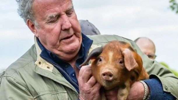 Jeremy Clarkson holding a pig, during the programme Clarkson's Farm