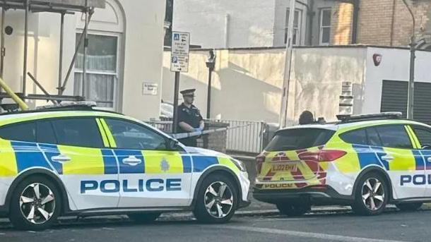 Two police cars at the scene of an alleged kidnapping in Hove