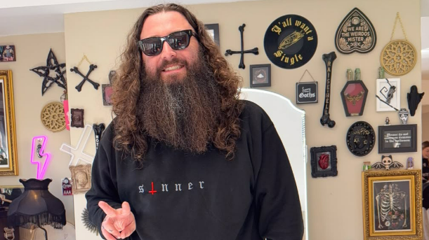 A man in shades posing in his salon