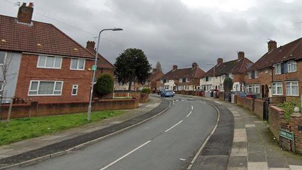Semi-detached houses on either side of a road, with a road sign on the right hand side saying 'Radway Road'.