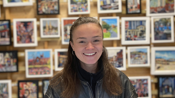 Shauna Fox at Belfast Christmas market in front of pictures