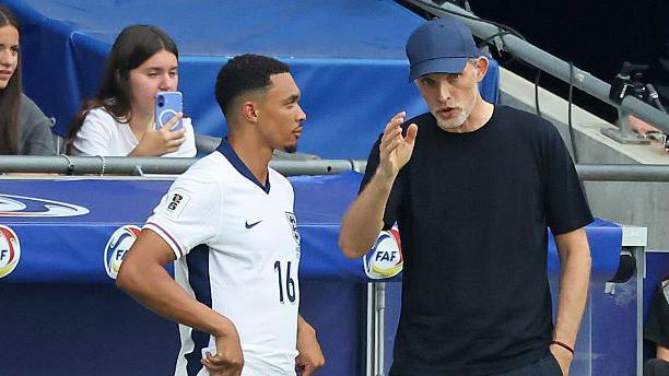 Trent Alexander-Arnold speaking to England manager Thomas Tuchel during a match against Andorra