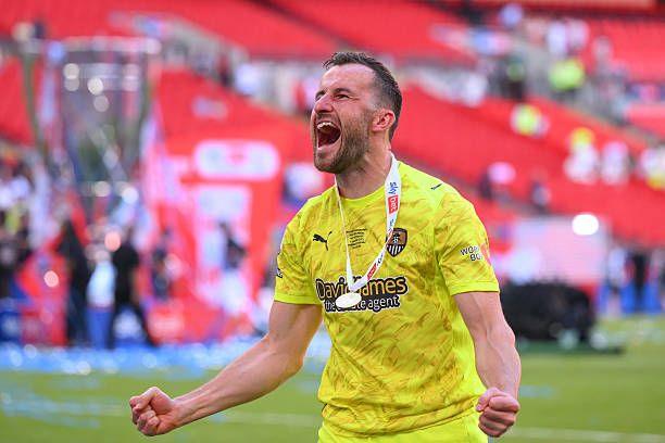 Notts County goalkeeper James Belshaw celebrating his side's promotion to League One.