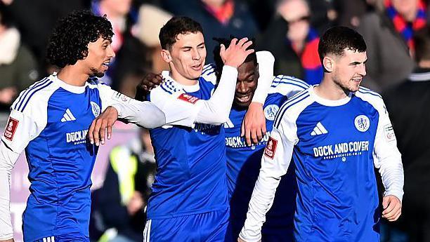 Macclesfield's players celebrate during the match against Crystal Palace