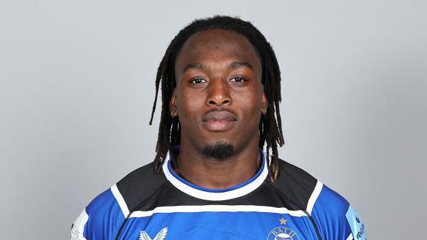 Khalik Kareem standing wearing Bath kit in 2024