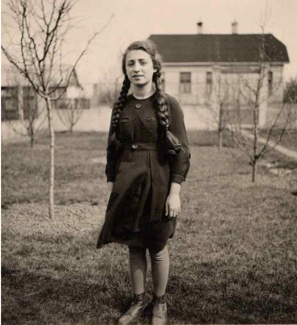 Gabriele Keenaghan standing in a garden with a house behind in Vienna in 1938